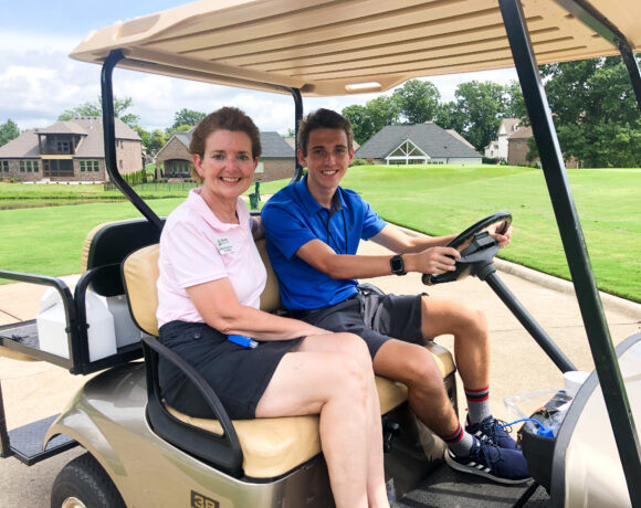 2020 President Shellie Tucker and her nephew on a golf cart at Foxland golf course