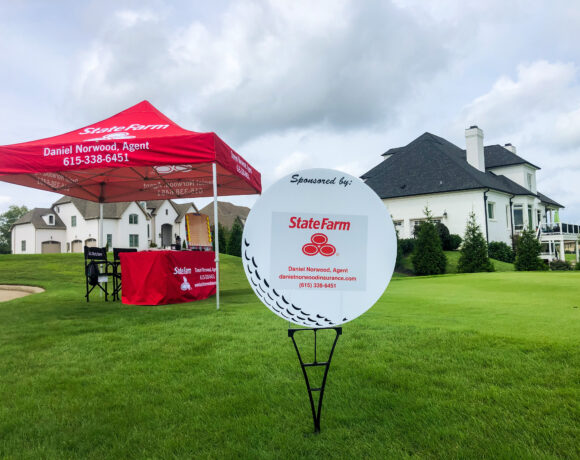 State farm sponsorship sign and tent at Foxland Golf course