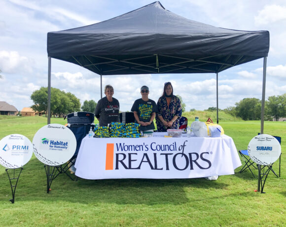 Employees of Women's Council of Realtors and Habitat for Humanity of Sumner County posing under a tent at Foxland golf course
