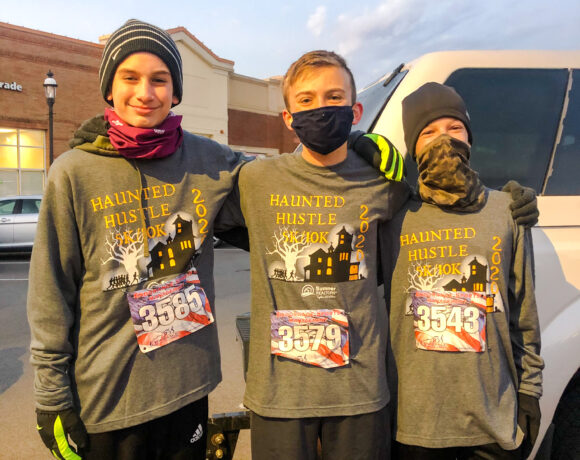 Group of runners wearing 2020 Haunted Hustle event shirts